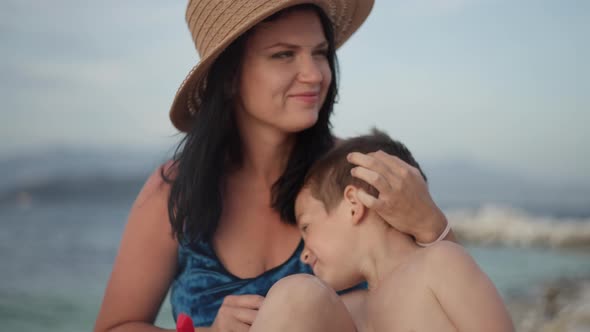 Mom and Son Resting By the Sea alt