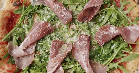 Delicious Pizza with Prosciutto Parma Ham Arugula Salad Rocket with Ingredients alt