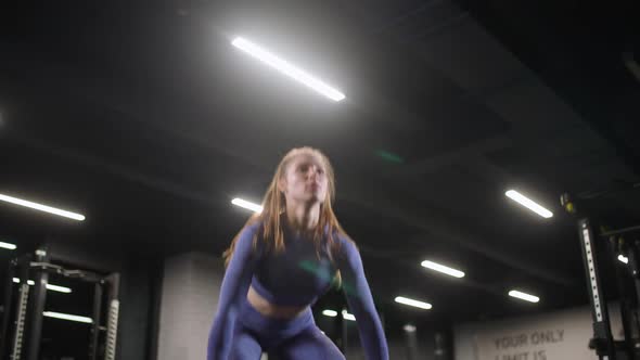 Strong Woman Athletic Female Performs Exercises with Kettlebells Lifts Weights and Does Kettlebell alt