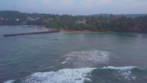Asian Men Sail on Boat Along Ocean with Waves Bird Eye View