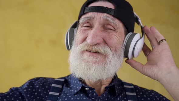 Satisfied Bearded Stylish Man in Headphones which Listening Modern Songs alt