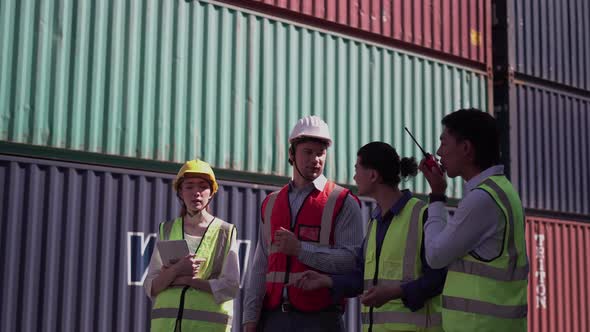 Dock worker team meeting in shipyard, Engineer and foreman in hardhat
