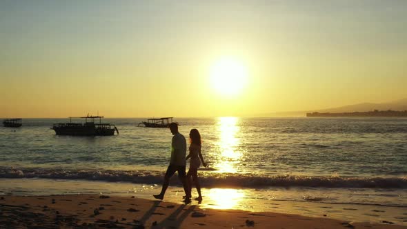 Teenage lovers posing on marine island beach voyage by blue sea with white sand background of Indone alt