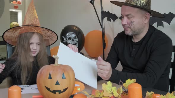 Little Girl and Her Dad Having Fun Together Happy Family Preparing to Celebrate Halloween alt