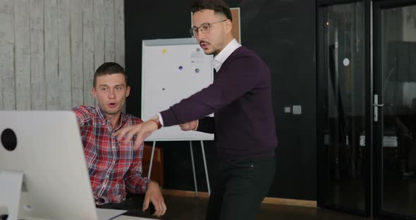 Man Emotionally Discuss What is Happening on the Monitor alt