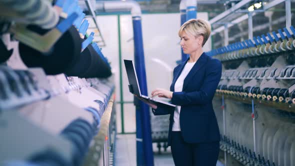 Businesswoman is Observing Textile Factory Equipment alt