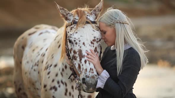 Beautiful Lady with Her White Stallion on Seashore Enjoying Nature