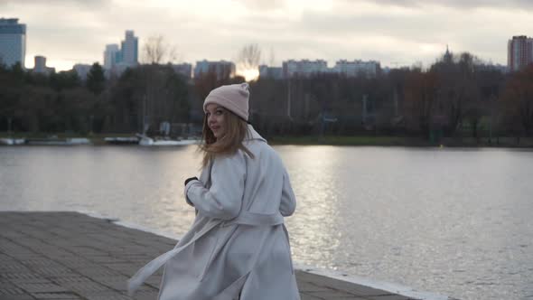 A Girl Runs Along the Embankment