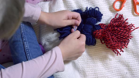 Girls Making Dolls From Strings.