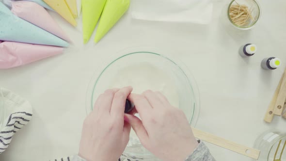 Time lapse. Step by step. Flat lay. Mixing royal icing to decorate Easter sugar cookies. alt