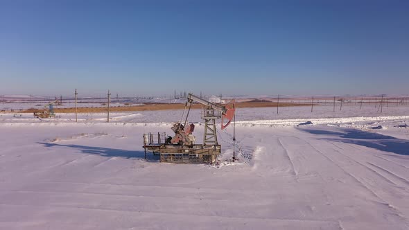 Pump Jack in Vast Oil Fields in Winter alt