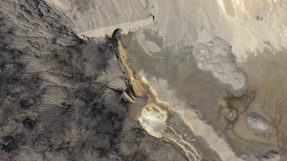 Descending on mine drainage and polluted river coast 4K drone video alt