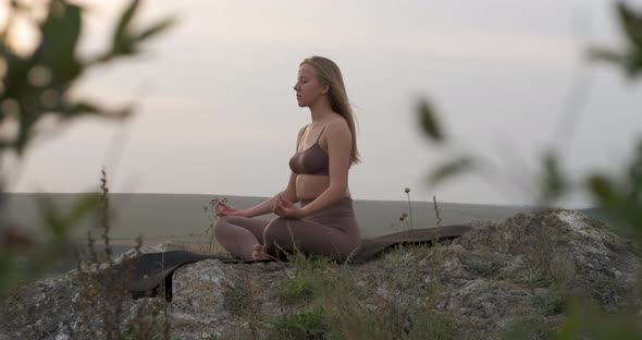 Young Woman Practicing Yoga on the Nature at Sunset Athletic Caucasian Girl Meditating Outdoors