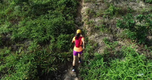 Aerial view of two women  friends  ultramarathon runners running uphill on mountain alt