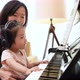 Asian mother and daughter practice piano together with happiness music class. - VideoHive Item for Sale
