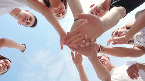 Friendly Friends Clasp Hands As a Sign of Strong Friendship and Teamwork alt