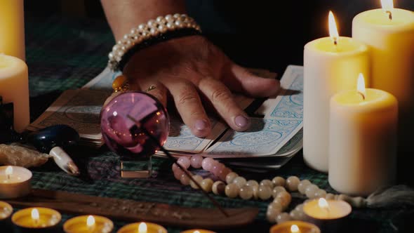 Female hands folding tarot cards alt