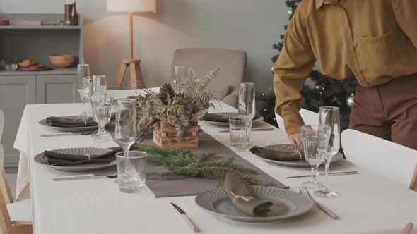 Decorator Adding Finishing Touches to Festive Table alt