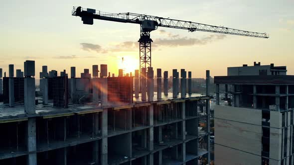 Sunset Construction Site with a Multistory House and a Crane alt