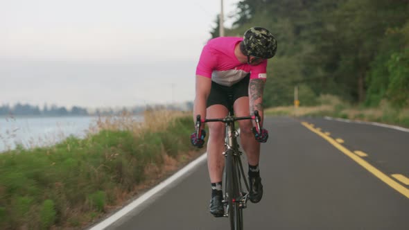 Tracking shot of a male cyclist on country road.  Fully released for commercial use.