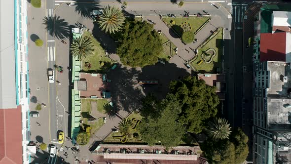 Overhead View Of Parque la Basilica And Vehicles Driving In The Street At Baños de Agua Santa, Ecuad alt