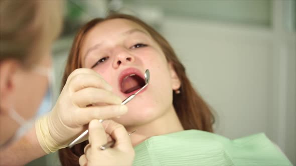 Orthodon Checks the Teeth of a Teenager Who Has Come to the Clinic for Treatment alt