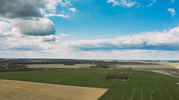 Clouds In Sky Above Countryside Rural Field Landscape In Spring Summer Day alt