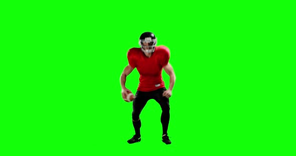 American football player holding ball alt