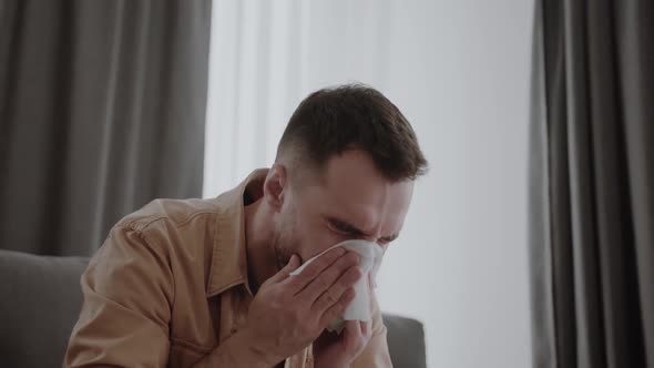 Ill Young Man Sneezing in Handkerchief Blowing Wiping Running Nose Sick Allergic Guy Caught Cold Got alt