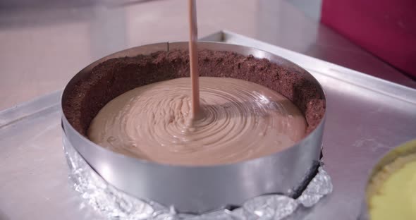 Professional Pastry Chef Pouring Melted Chocolate on Cake