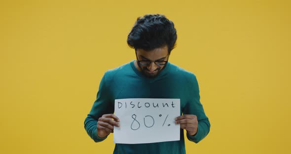 Young Man Holding Discount Sign alt