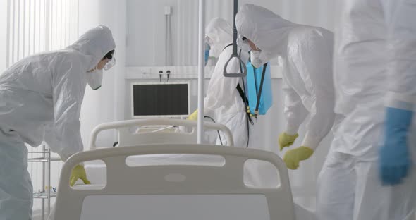 Medical Staff in Ppe Suit Disinfecting Hospital Ward and Changing Bedsheets alt