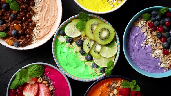 Various Healthy Fresh Smoothies or Yogurts in Bowls, With Strawberries, Kiwi, Chia, Blackberries alt
