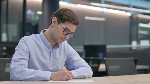 Young Man Having Failure Writing on Paper alt