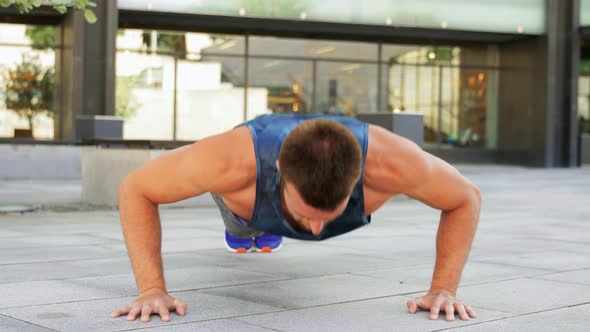 Young Man Doing Push Ups on City Street alt