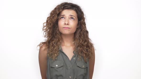 Thoughtful Young Woman with Long Curly Hair Expressing Denial Nodding ...