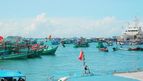 Aerial shot of fishing boat sailing in the harbour of Viretnam. Traditional fishermen boats lined in alt