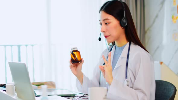 Portrait of young asian woman doctor with white coat standing in hospital.Telemedicine alt