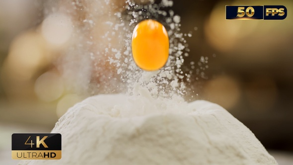 Egg Falling on a Bunch of Flour for making a Dough for Homemade Pasta