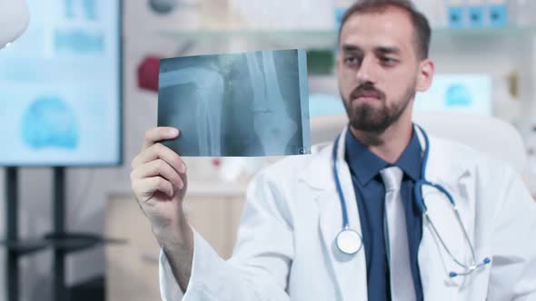 Close Up of Doctor Looking at X Ray Scan of a Leg alt