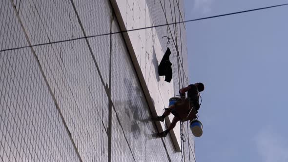 Industrial Climber Insulation of Facade Old High-Rise Building Using Styrofoam alt