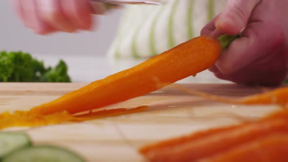 Peeling carrots, closeup alt