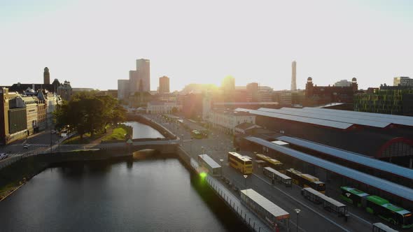 Drone flying towards Malmö Central Station in sunset. Turning torso in background alt