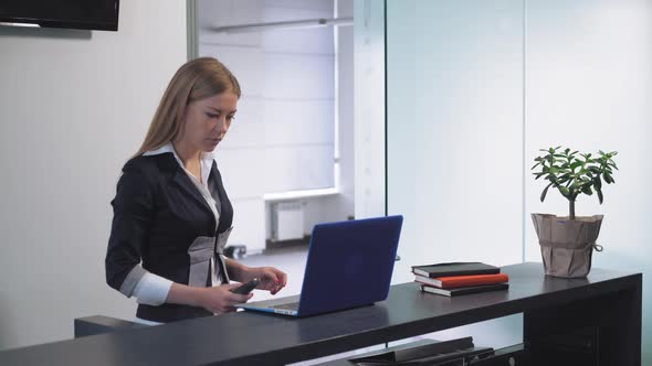 Female Has Phone Conversation at Service Desk alt