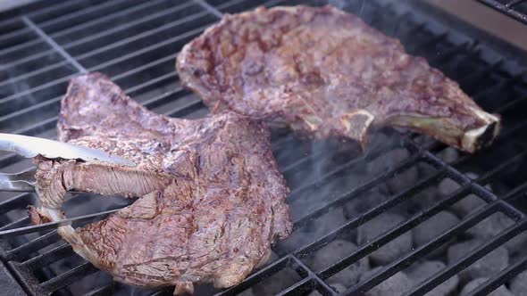 Steak on charcoal barbecue showing medium to well done degree of doneness. alt