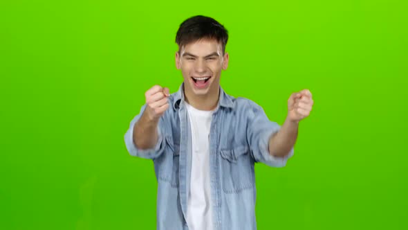 Young Guy Is Happy with His Victories, He Is Happy. Green Screen alt