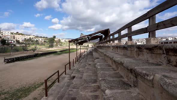 Hipodrome Of Roman Ruins In The City Of Jerash With Wind Blasting Textile Roof Over Viewers Section alt