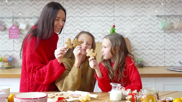 Happy Family Mother and Daughters Bake Cookies for Christmas
