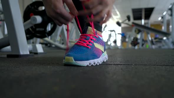 Running Shoes  Woman Tying Shoe Laces in the Gym alt