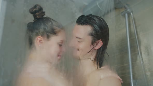 Beautiful Couple Kissing While Washing in Shower Together in Modern Hotel alt